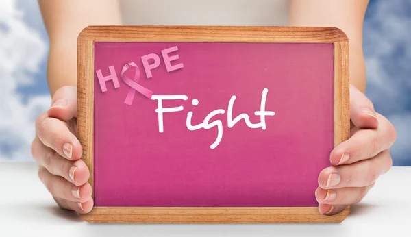 Composite image of females hands showing pink board — Stock Photo, Image