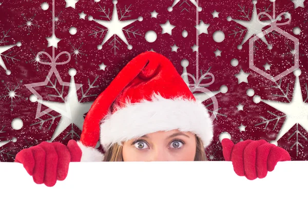 Composite image of festive blonde holding a poster — Stock Photo, Image