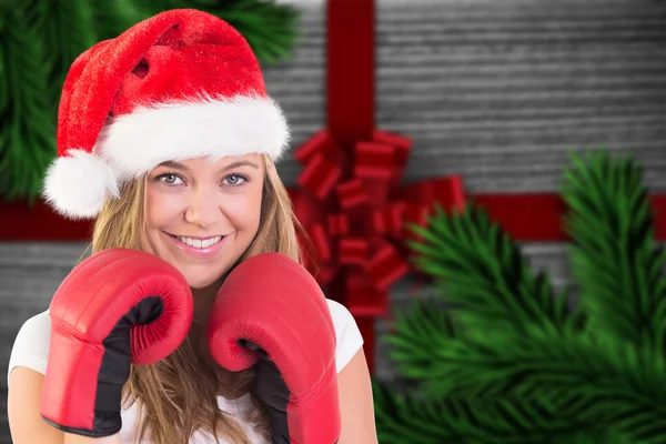 Composite image of festive blonde with boxing gloves — Stock Photo, Image