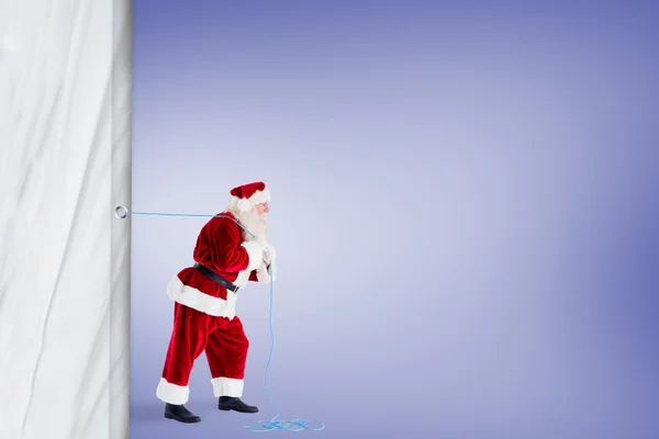 Santa Claus tirando de una cuerda — Foto de Stock