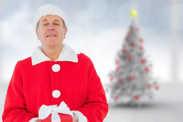 Samengestelde afbeelding van feestelijke man met cadeau — Stockfoto