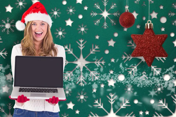 Composite image of festive blonde showing a laptop — Stock Photo, Image