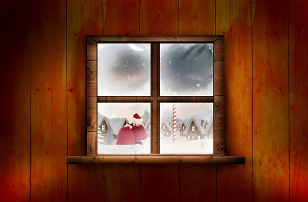 Papai Noel entrega presentes contra janela — Fotografia de Stock