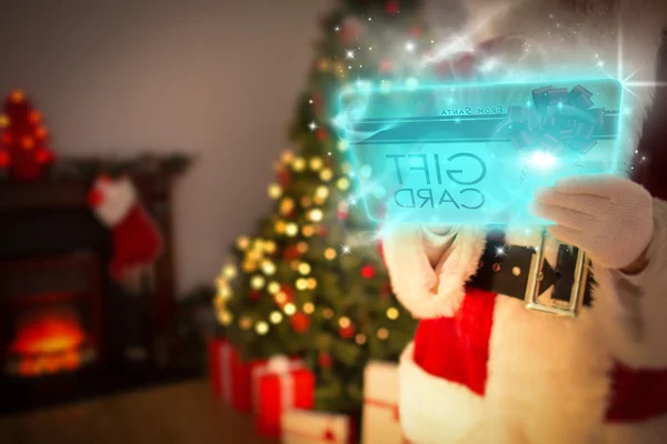 Verbundbild des Weihnachtsmannes mit futuristischem Touchscreen — Stockfoto