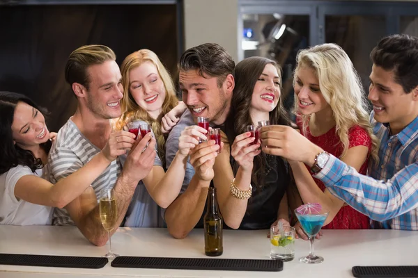 Happy friends having a drink together — Stock Photo, Image