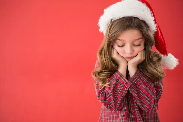 Trauriges kleines Mädchen mit Weihnachtsmütze — Stockfoto