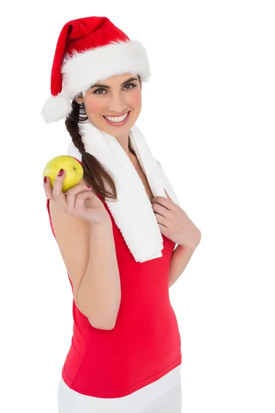 Праздничная брюнетка держит яблоко — стоковое фото