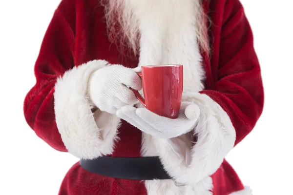 Santa sostiene una taza roja —  Fotos de Stock