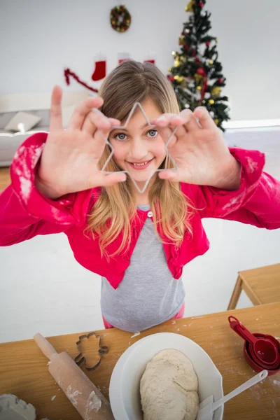Праздничная маленькая девочка печет рождественское печенье — стоковое фото