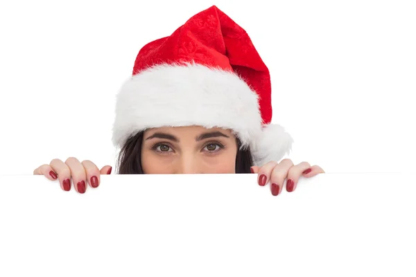 Festive brunette showing white poster — Stock Photo, Image