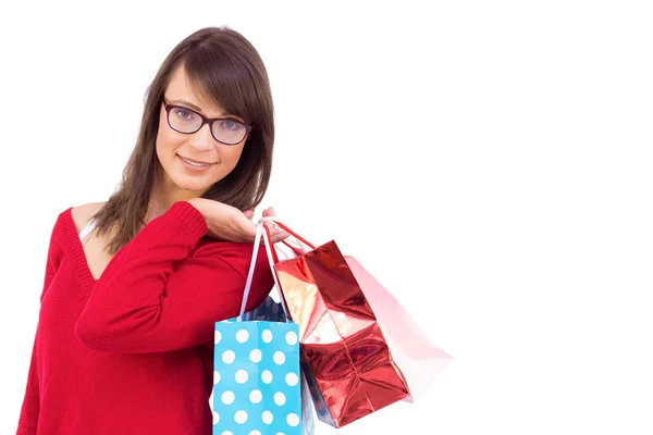 Gelukkig brunette bedrijf shopping tassen — Stockfoto