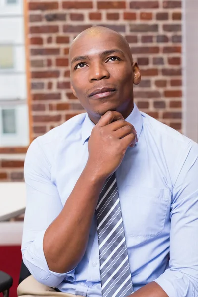 Thoughtful businessman looking up in office — Stock Photo, Image