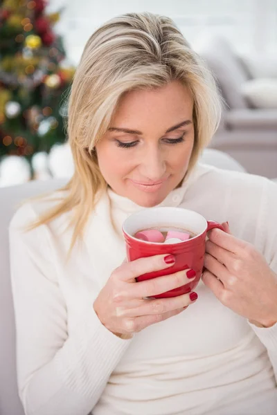 Rubia teniendo chocolate caliente en el sofá en Navidad — Foto de Stock