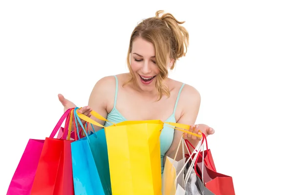 Excited woman looking at many shopping bags — Stock Photo, Image