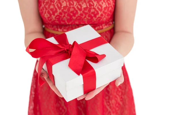 Pretty woman in red dress offering present — Stock Photo, Image