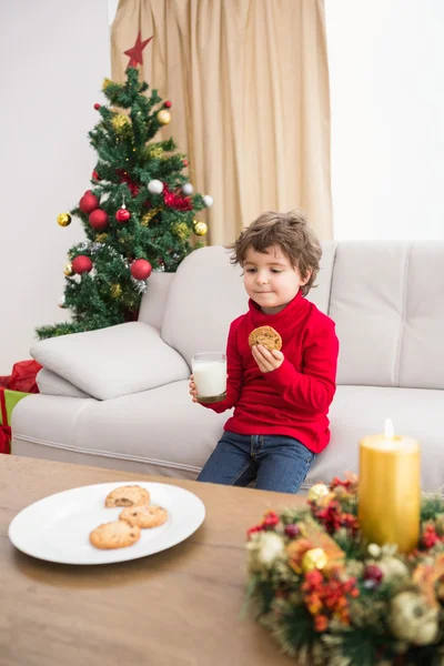 Festive little boy having milk and cookies — Stock Photo, Image