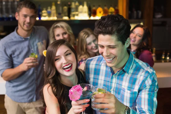 Happy friends drinking cocktails together — Stock Photo, Image