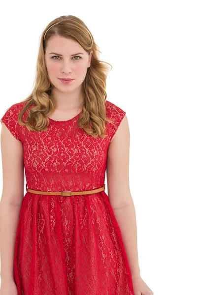 Beautiful woman wearing red dress smiling at camera — Stock Photo, Image