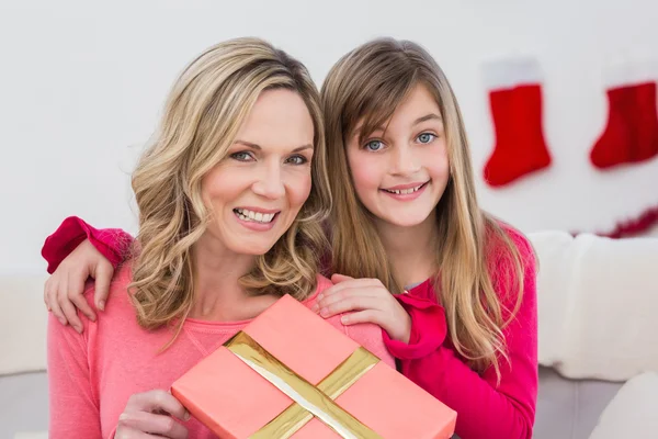 Festive mother and daughter smiling at camera — Stock Photo, Image