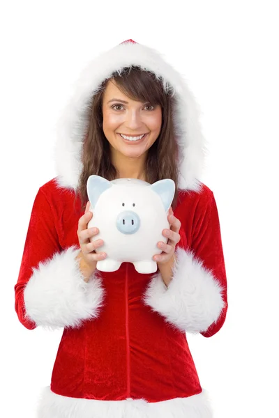 Lachende brunette in santa claus houden een piggy bank — Stockfoto