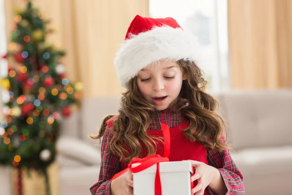 Festive little girl opening a gift — Stock Photo, Image