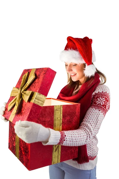 Young woman in stylish warm clothing opening a gift — Stock Photo, Image