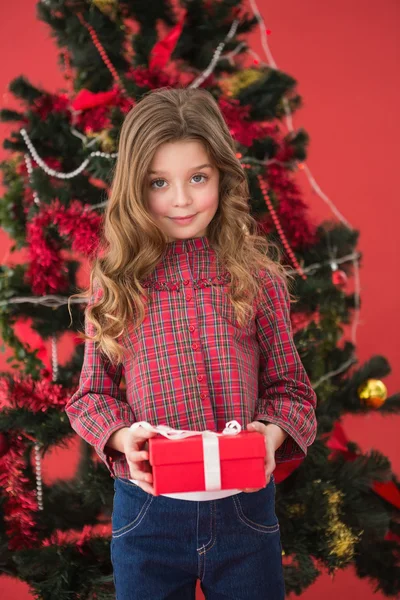 Festive little girl holding a gift — Stock Photo, Image