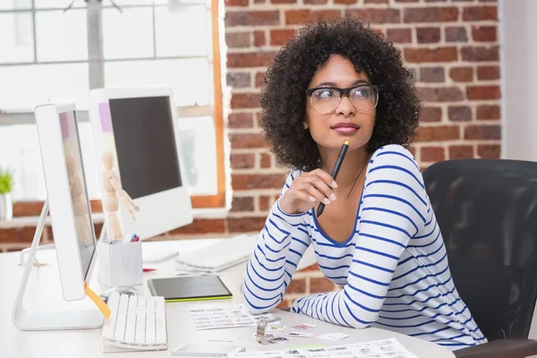 Thoughtful female photo editor in office — Stock Photo, Image