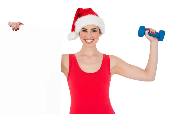 Festive fit brunette holding page and dumbbell — Stock Photo, Image