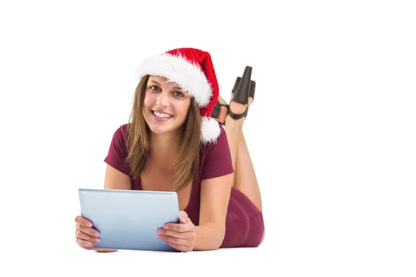 Festive brunette using tablet pc — Stock Photo, Image