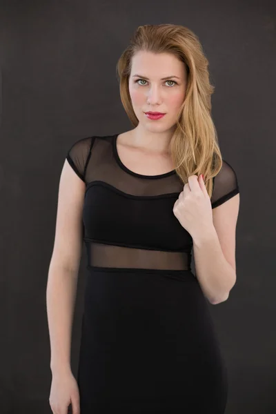 Pretty blonde wearing sexy black dress posing — Stock Photo, Image