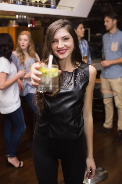 Pretty brunette holding a cocktail — Stock Photo, Image