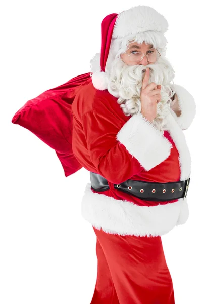 Santa κρατώντας ένα μυστικό και κρατά το σάκο του — Φωτογραφία Αρχείου