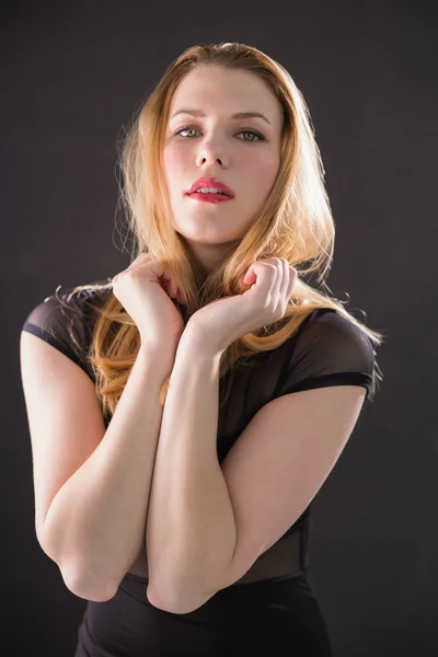 Blonde model in black dress posing looking at camera — Stock Photo, Image