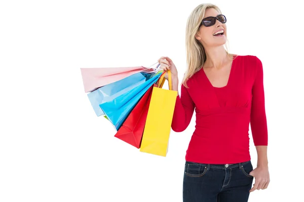 Gelukkig blonde bedrijf shopping tassen — Stockfoto