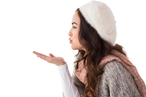 Brunette in winter clothes blowing kiss — Stock Photo, Image