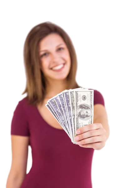 Festive brunette in dress showing her cash — Stock Photo, Image