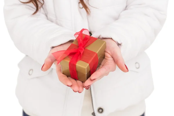 Woman in white coat holding gift — Stock Photo, Image
