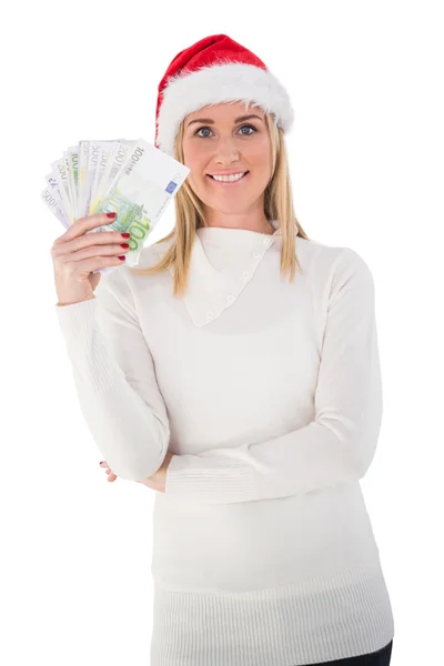 Loira festiva segurando seu dinheiro — Fotografia de Stock