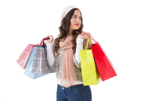 Doordachte brunette met shopping tassen — Stockfoto