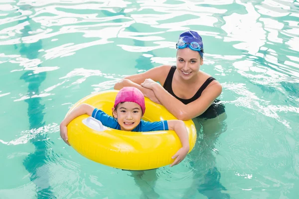 Cute little boy learning to swim with coach — Stock Photo, Image