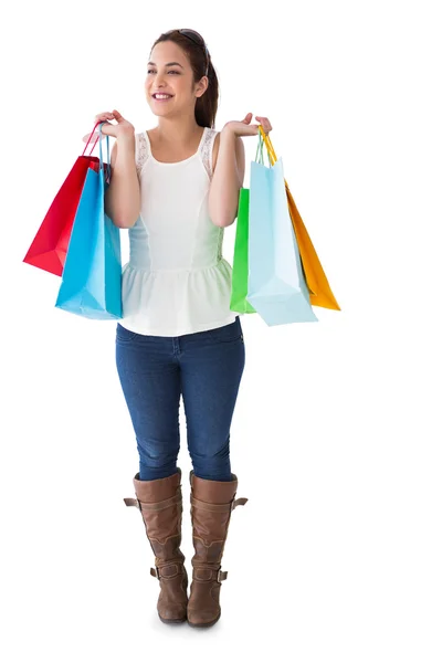 Morena feliz posando com sacos de compras — Fotografia de Stock