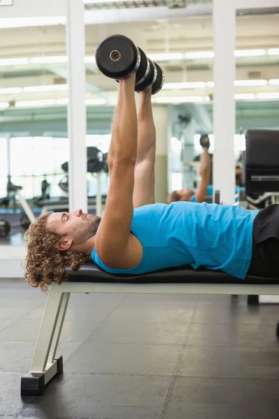 Man exercising with dumbbells in gym — Stock Photo, Image