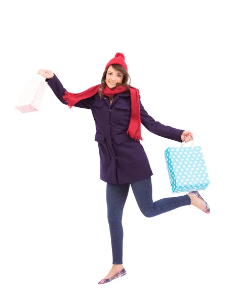 Festive brunette holding shopping bags — Stock Photo, Image