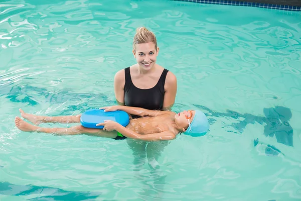 Cute little boy learning to swim with coach — Stock Photo, Image