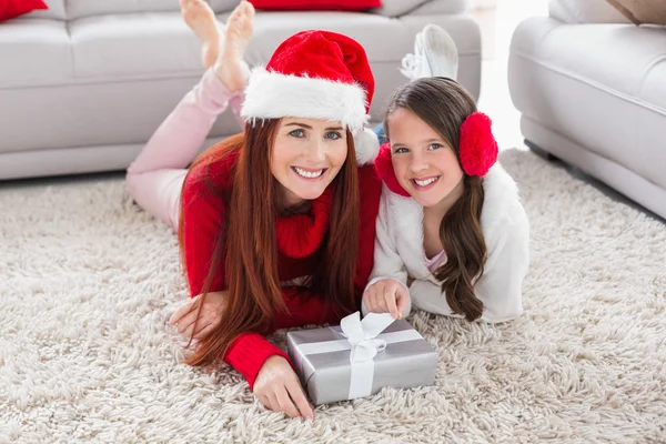 Festive mother and daughter smiling at camera — Stock Photo, Image