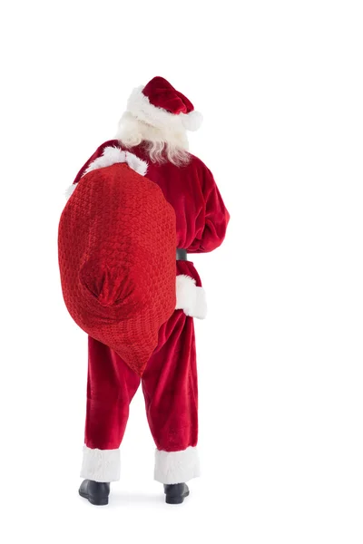 Santa draagt zijn zak weg — Stockfoto