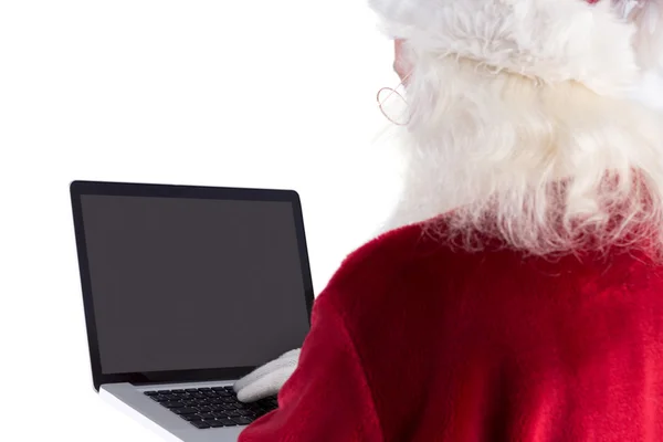 Santa Claus używa laptopa — Zdjęcie stockowe