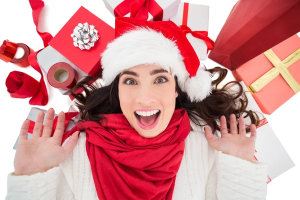 Excited brunette lying near christmas presents — Stock Photo, Image