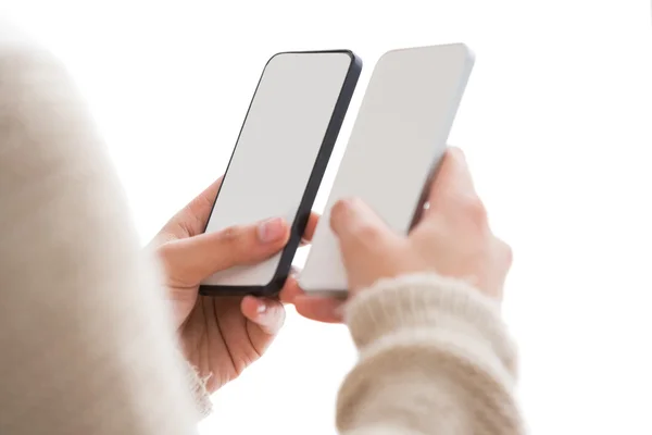 Close up of woman holding smartphones — Stock Photo, Image